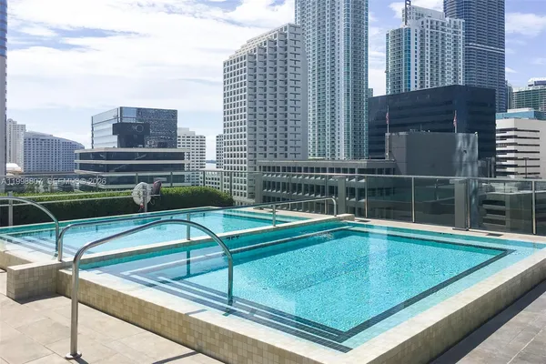 a view of a pool with chairs