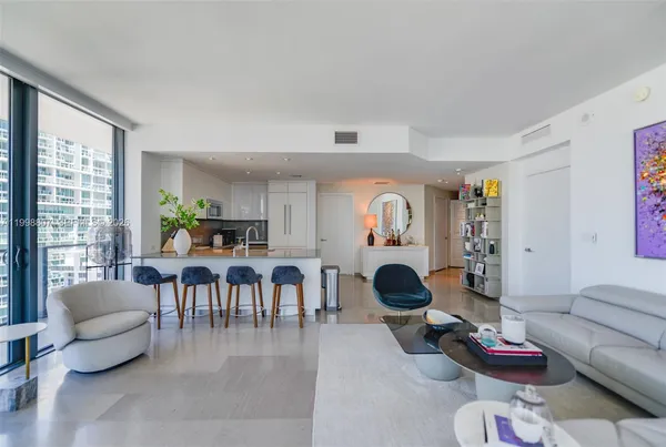 a living room with furniture potted plant and a window