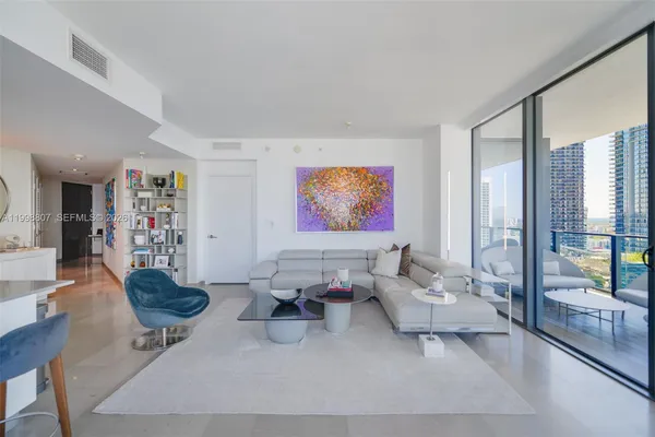 a living room with furniture and a large window