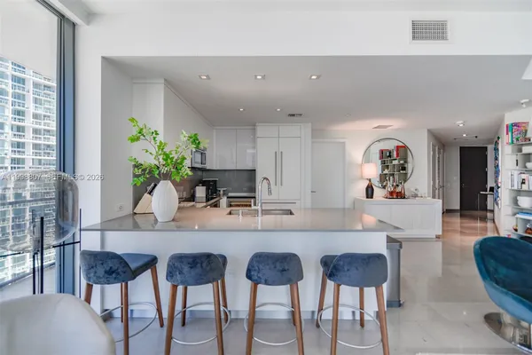 a view of a dining room kitchen with a table chairs and entryway