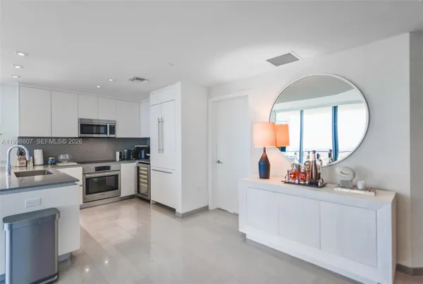 a kitchen with white cabinets and a stove