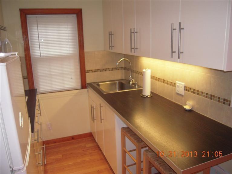 49 Lower County Road, Unit 16 Dennis Port, MA 02639 - Photo 1 of 12 a kitchen with a sink a counter top space and cabinets