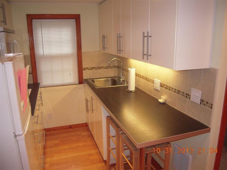 49 Lower County Road, Unit 16 Dennis Port, MA 02639 - Photo 12 of 12 a view of a kitchen with a sink and cabinets