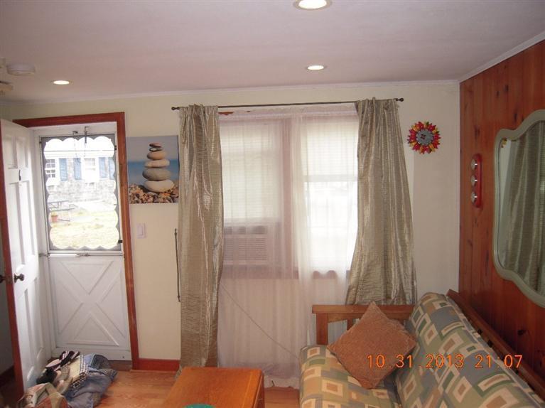 49 Lower County Road, Unit 16 Dennis Port, MA 02639 - Photo 2 of 12 a bedroom with a bed and a window