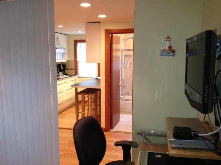 49 Lower County Road, Unit 16 Dennis Port, MA 02639 - Photo 4 of 12 a view of a hallway with workspace and living room