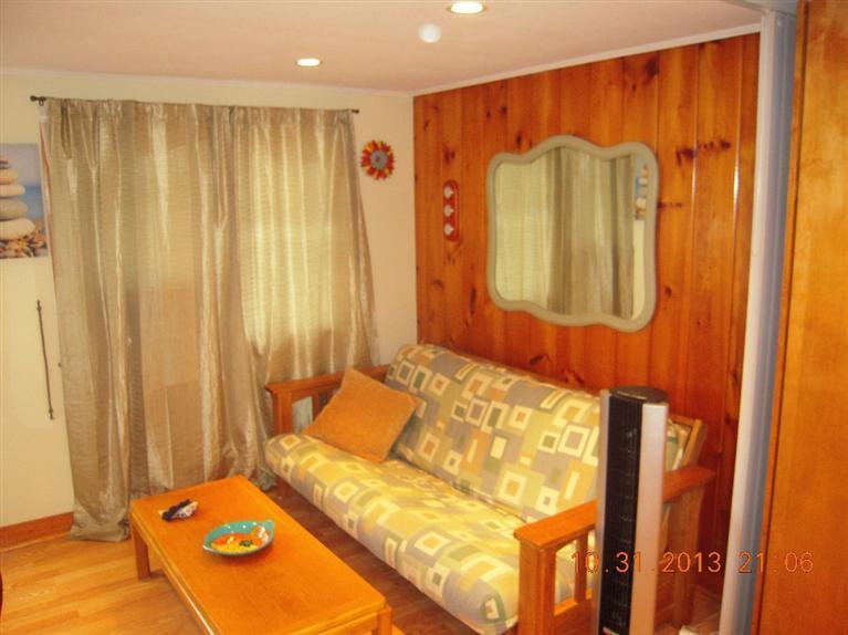 49 Lower County Road, Unit 16 Dennis Port, MA 02639 - Photo 7 of 12 a bedroom with a bed and a chair