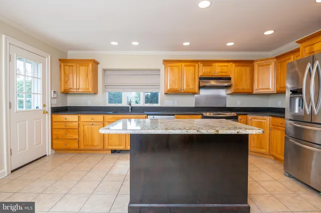 a kitchen with stainless steel appliances granite countertop a sink and a stove