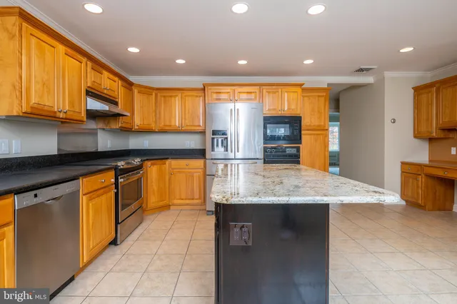 a kitchen with stainless steel appliances granite countertop a sink and cabinets