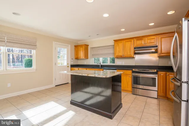 a kitchen with stainless steel appliances granite countertop a stove and a sink