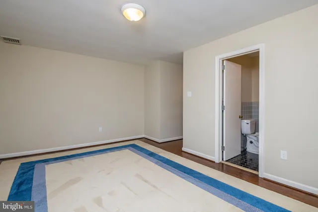 a bathroom with a bathtub shower sink vanity and a toilet