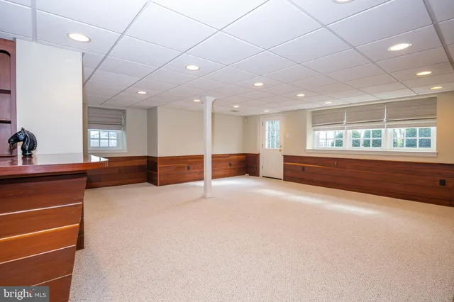 a view of a house with a swimming pool and a yard