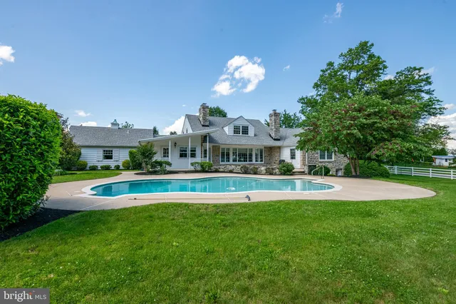 an aerial view of a house with yard swimming pool and outdoor seating