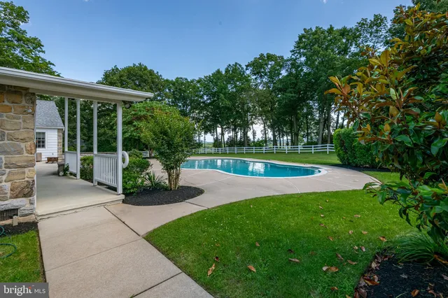 an aerial view of a house with outdoor space and tennis court