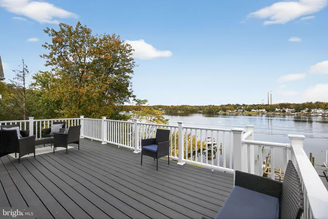 a balcony with wooden floor and lake view