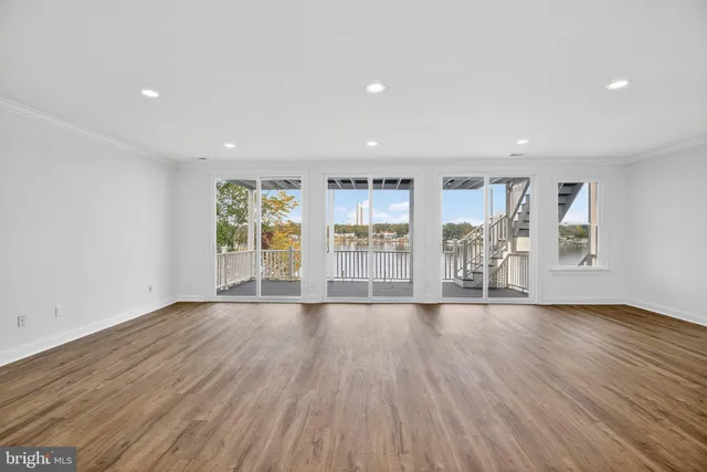 a living room with fireplace furniture and a kitchen view
