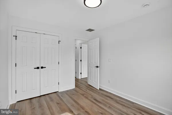 a balcony with wooden floor and outdoor seating