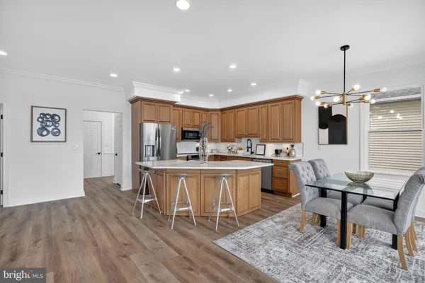 a kitchen with a sink cabinets and wooden floor