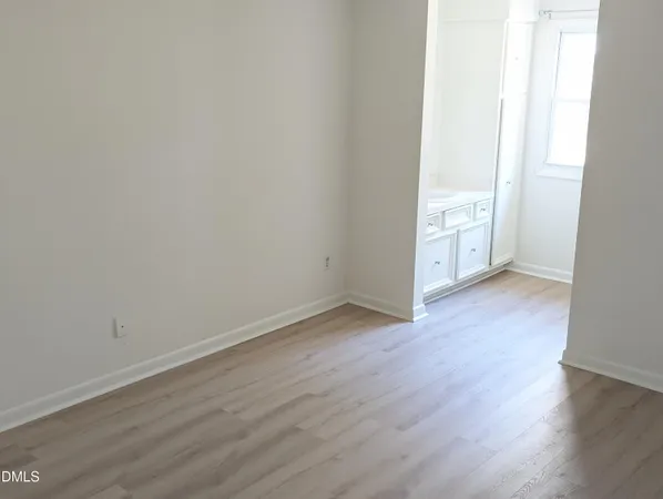 an empty room with wooden floor