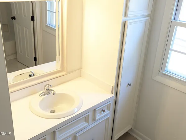 a bathroom with a sink and a window