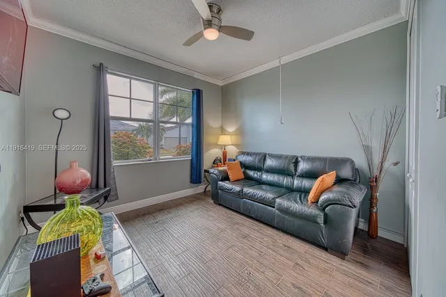 a living room with furniture flowerpot and window