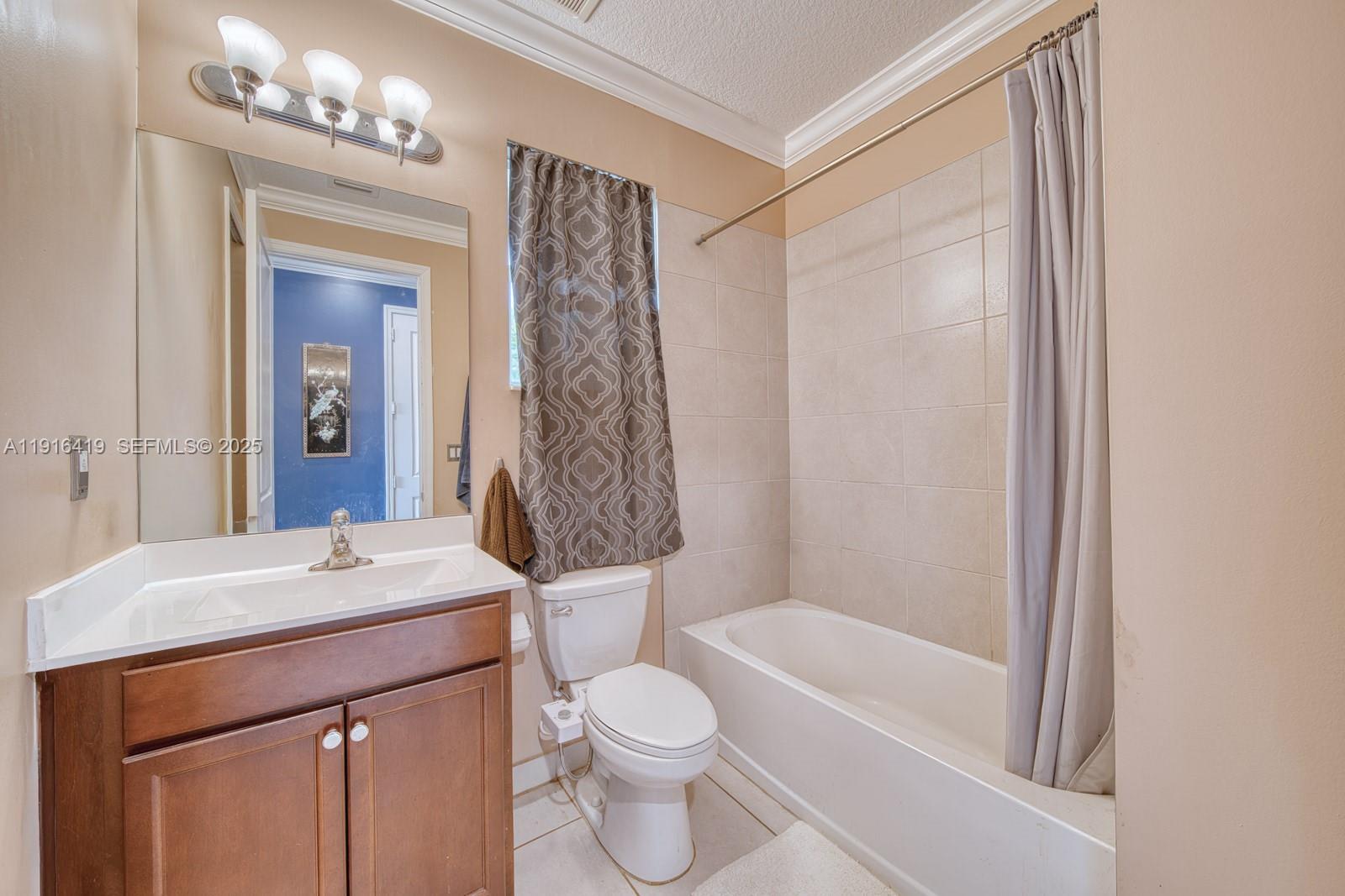 4147 Rosa Drive Deerfield Beach, FL 33064 - Photo 13 of 40 a bathroom with a sink a toilet a mirror and shower