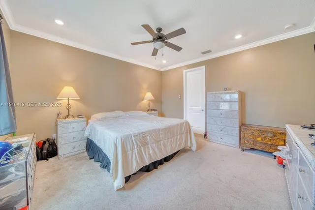 a bedroom with a bed and a ceiling fan