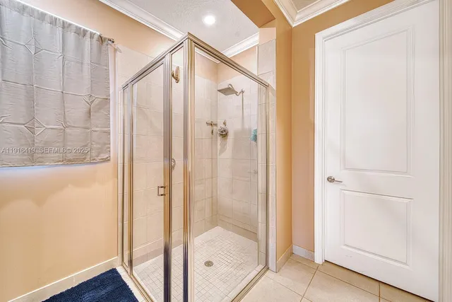 a bathroom with a glass shower door