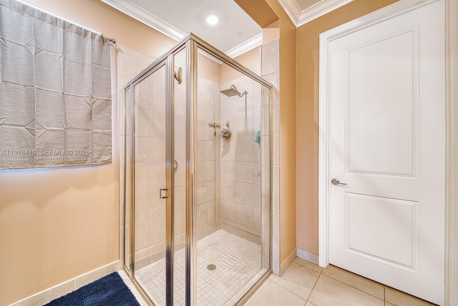 4147 Rosa Drive Deerfield Beach, FL 33064 - Photo 20 of 40 a bathroom with a glass shower door