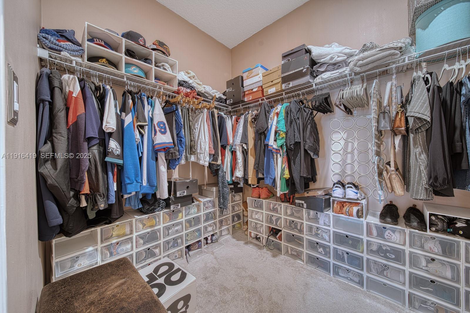 4147 Rosa Drive Deerfield Beach, FL 33064 - Photo 21 of 40 a view of walk in closet with clothes and shoes