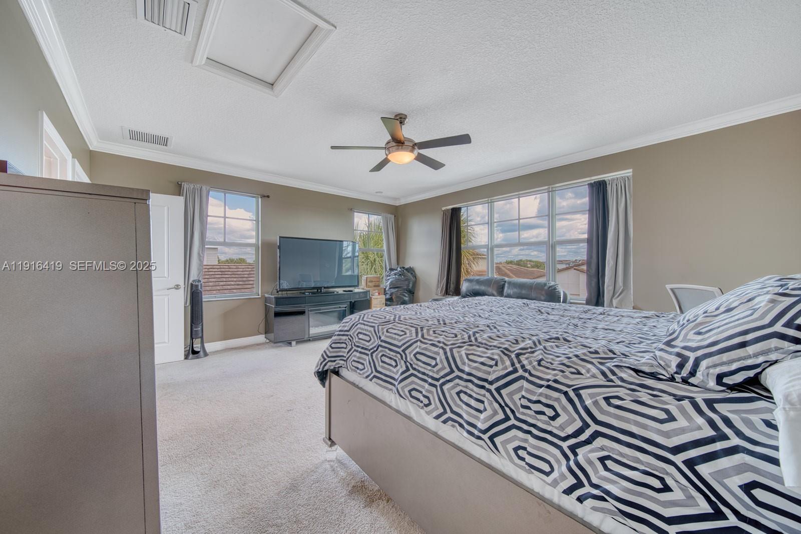 4147 Rosa Drive Deerfield Beach, FL 33064 - Photo 25 of 40 a bedroom with a bed and a chandelier