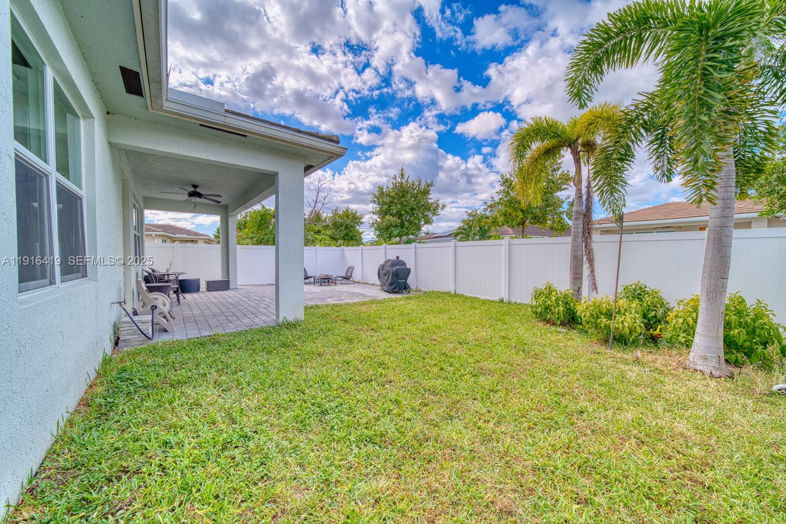 4147 Rosa Drive Deerfield Beach, FL 33064 - Photo 30 of 40 a view of a house with backyard and a tree