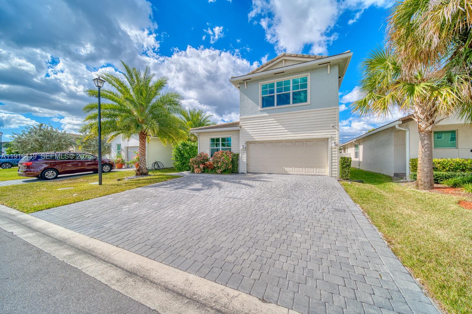 4147 Rosa Drive Deerfield Beach, FL 33064 - Photo 3 of 40 a front view of a house with a yard and a garage