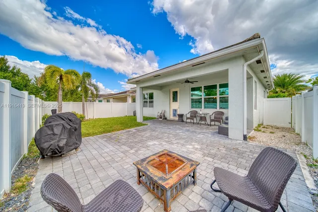 a view of backyard of house with seating space