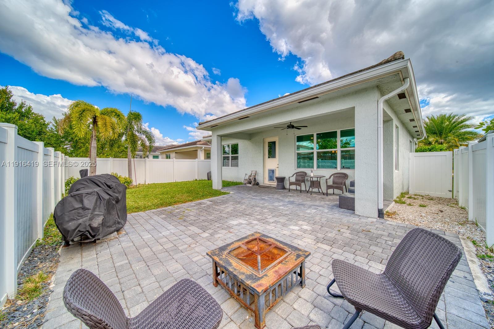 4147 Rosa Drive Deerfield Beach, FL 33064 - Photo 31 of 40 a view of backyard of house with seating space