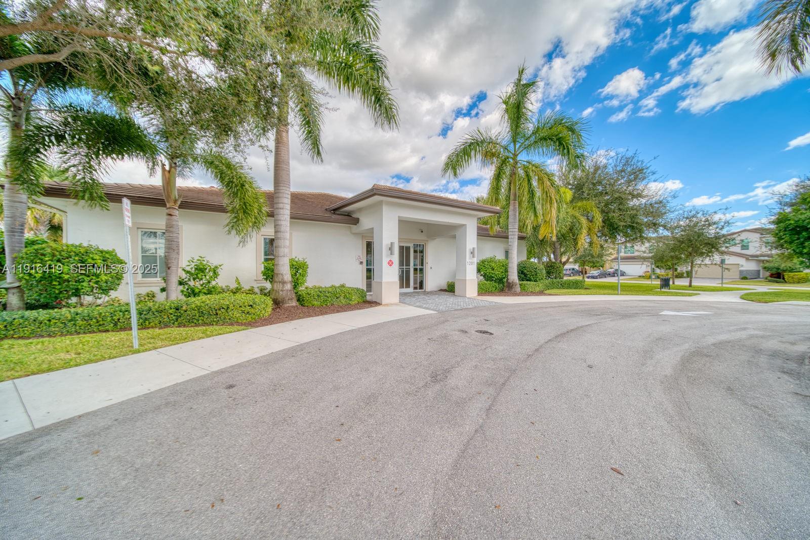 4147 Rosa Drive Deerfield Beach, FL 33064 - Photo 33 of 40 a view of a house with a big yard and palm trees