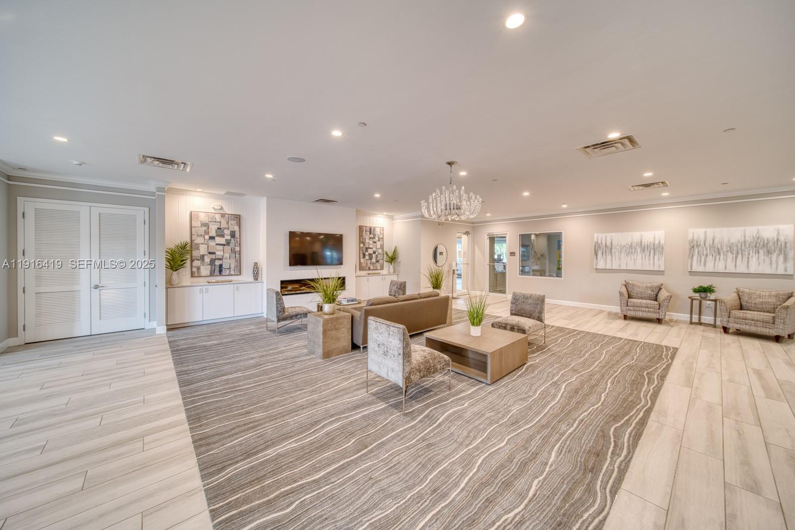 4147 Rosa Drive Deerfield Beach, FL 33064 - Photo 35 of 40 a living room with furniture a flat screen tv and kitchen view