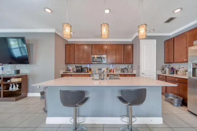 a large kitchen with a counter space a sink and cabinets