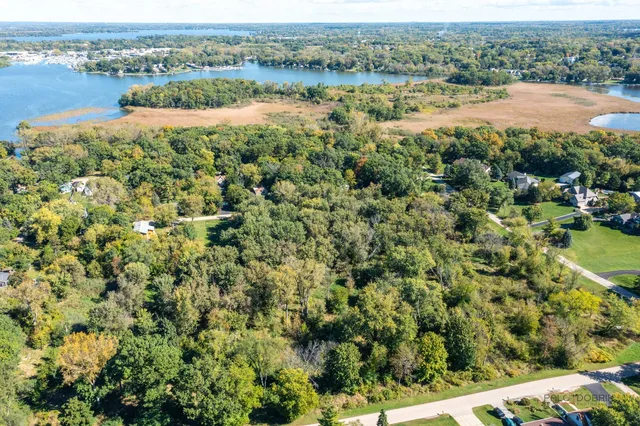 an aerial view of residential houses with outdoor space and river