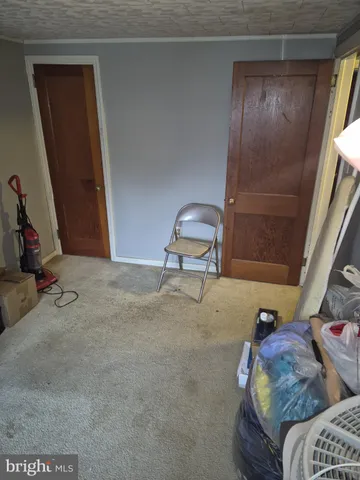 a view of a yard with wooden fence