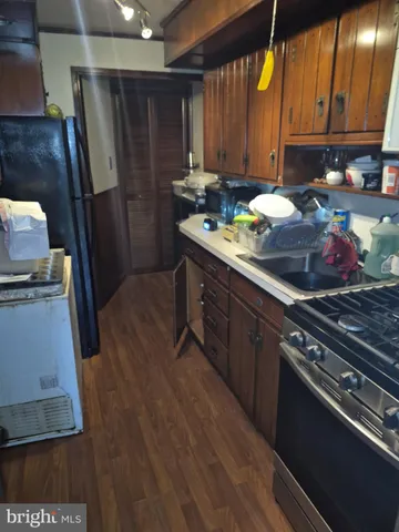 a kitchen with a sink stove and refrigerator
