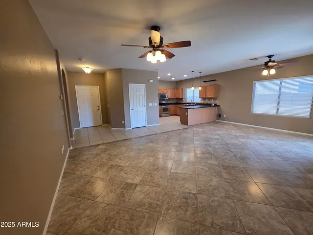 a view of a hallway with a ceiling fan