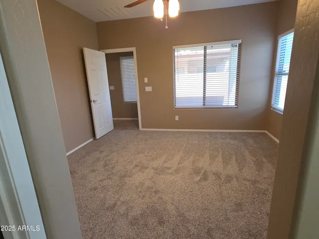 an empty room with windows and entrance