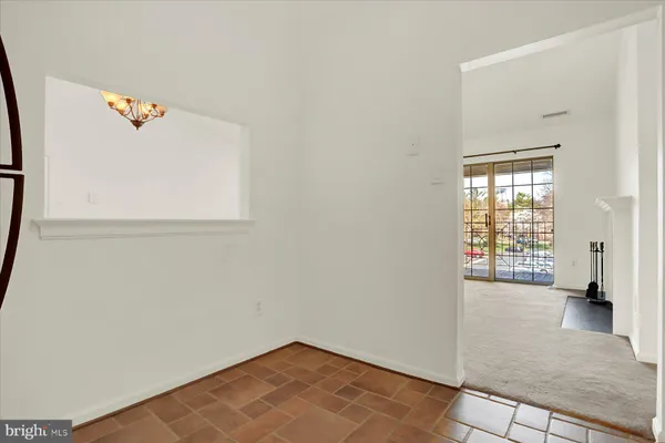 an empty room with wooden floor and a window