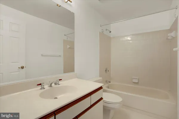 a bathroom with a sink mirror toilet and bathtub