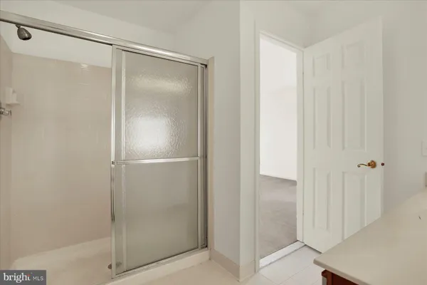 a bathroom with a glass shower door