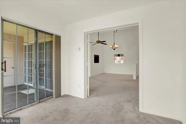 a view of a hallway with wooden floor and windows
