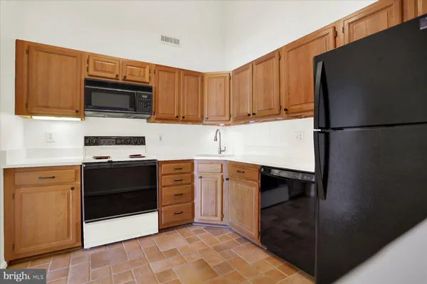 a kitchen with stainless steel appliances granite countertop a refrigerator stove and microwave