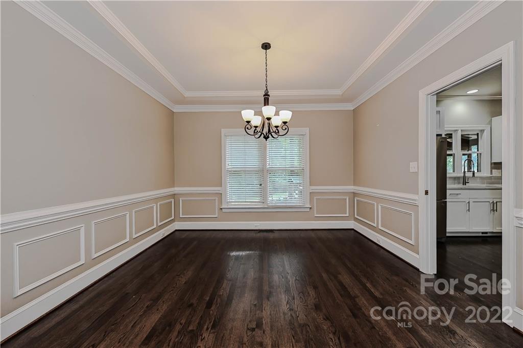 9528 Millen Drive Harrisburg, NC 28075 - Photo 11 of 48 a view of an empty room with wooden floor and a window
