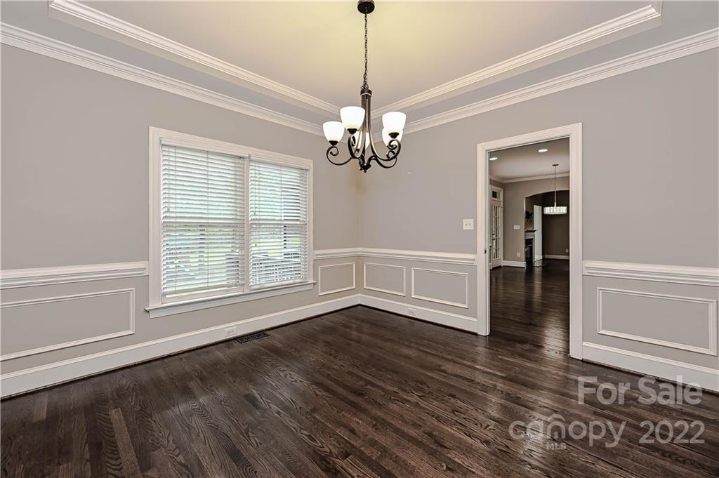 9528 Millen Drive Harrisburg, NC 28075 - Photo 12 of 48 a view of an empty room with wooden floor and a window