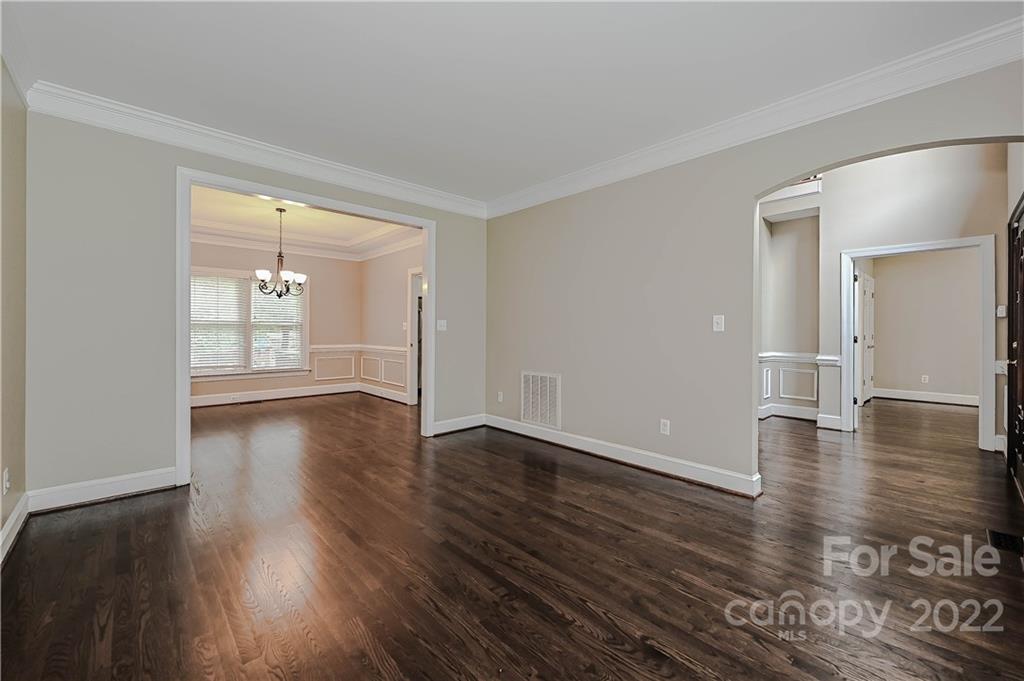 9528 Millen Drive Harrisburg, NC 28075 - Photo 15 of 48 a view of an empty room with window and wooden floor
